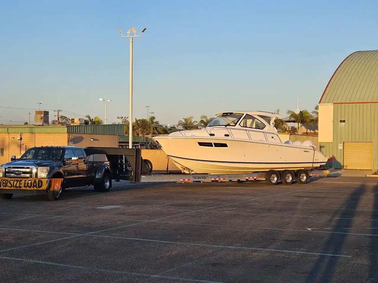Large boat being hauled on a flatbed trailer